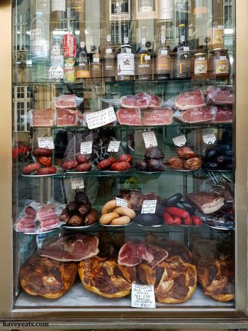 Window display of cured meats in Casa Arcozelo delicatessen in Porto, Portugal. 