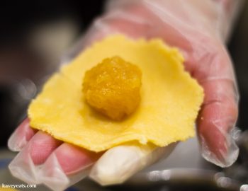 Placing pineapple jam filling into flattened pastry dough