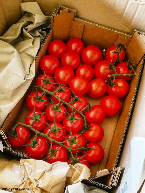 Box of fresh tomatoes on the vine