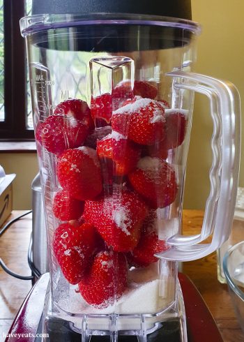 Strawberries and sugar in blender jug