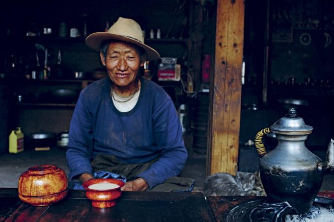 Yeshi's younger father taking butter tea - Taste Tibet