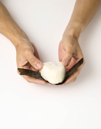 Step 1 in shaping omusubi (onigiri)